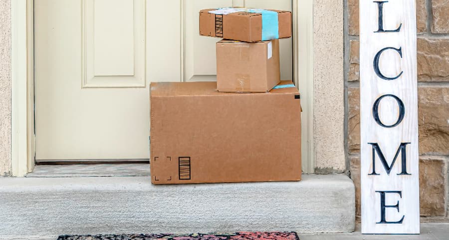 Deliveries on the front porch of a house with a welcome sign in New Orleans